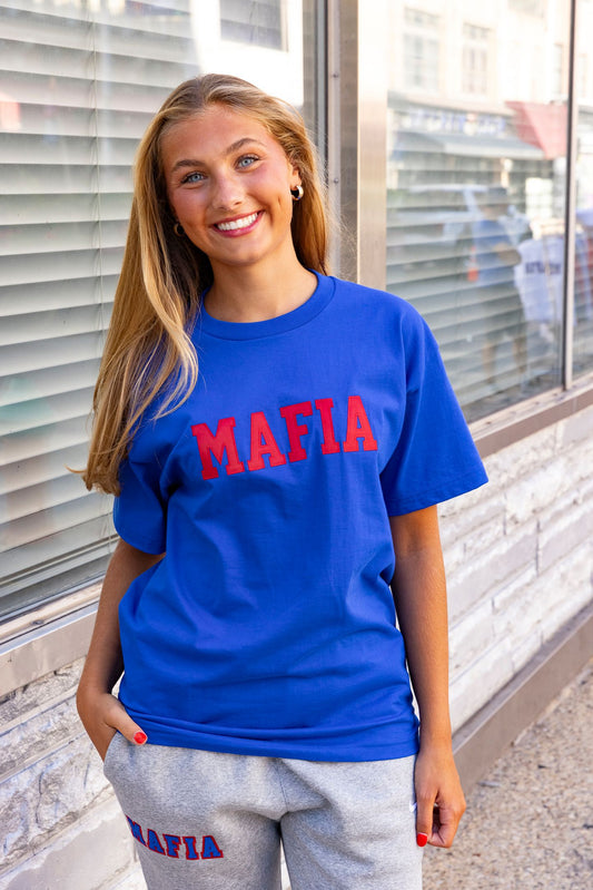Female model wearing royal blue MAFIA t-shirt with red sewn-on lettering