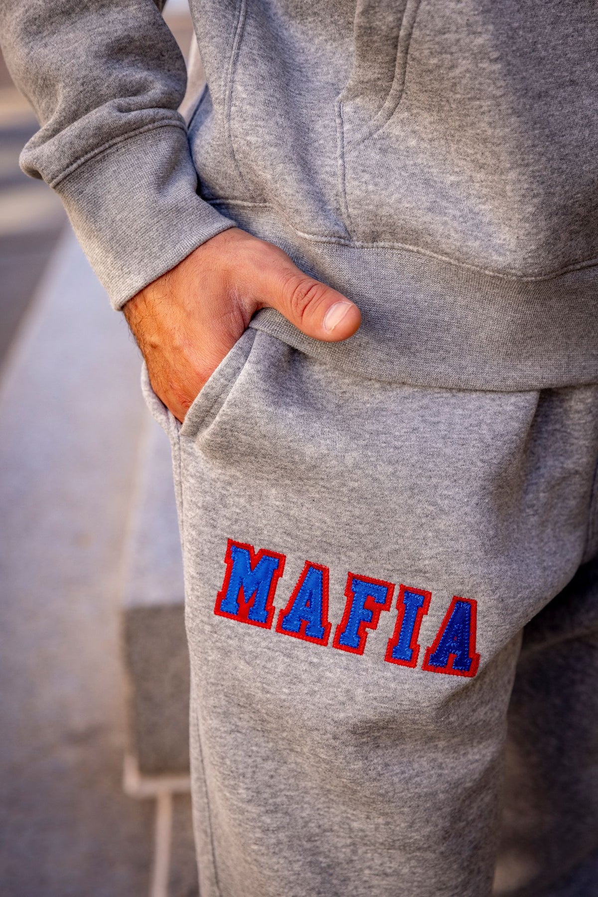 Model wearing grey MAFIA joggers with sewn-on lettering