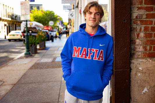 Male model wearing royal blue MAFIA hoodie with sewn-on lettering