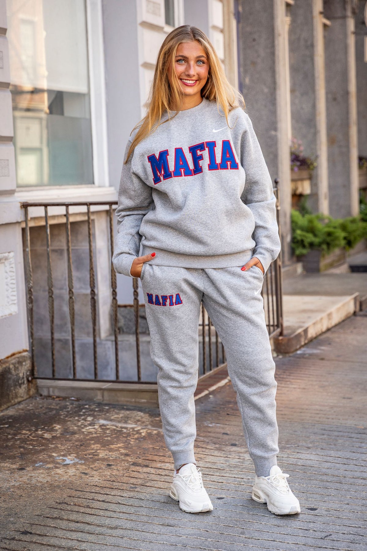 Female model wearing grey MAFIA crewneck with sewn-on lettering