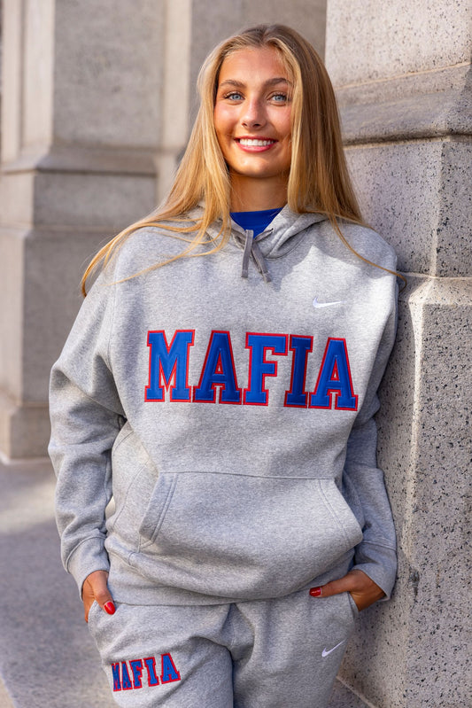 Female model wearing grey MAFIA hoodie with sewn-on lettering