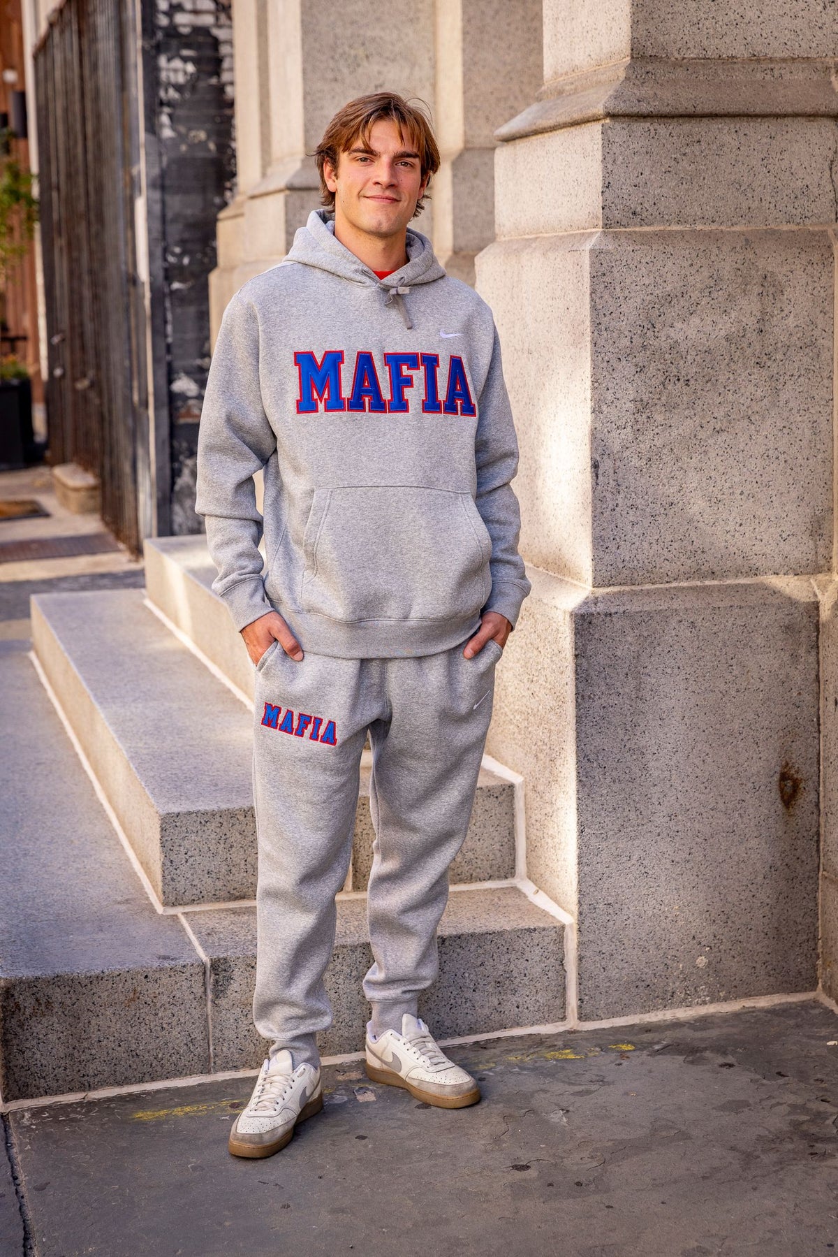 Male model wearing grey MAFIA hoodie with sewn-on lettering