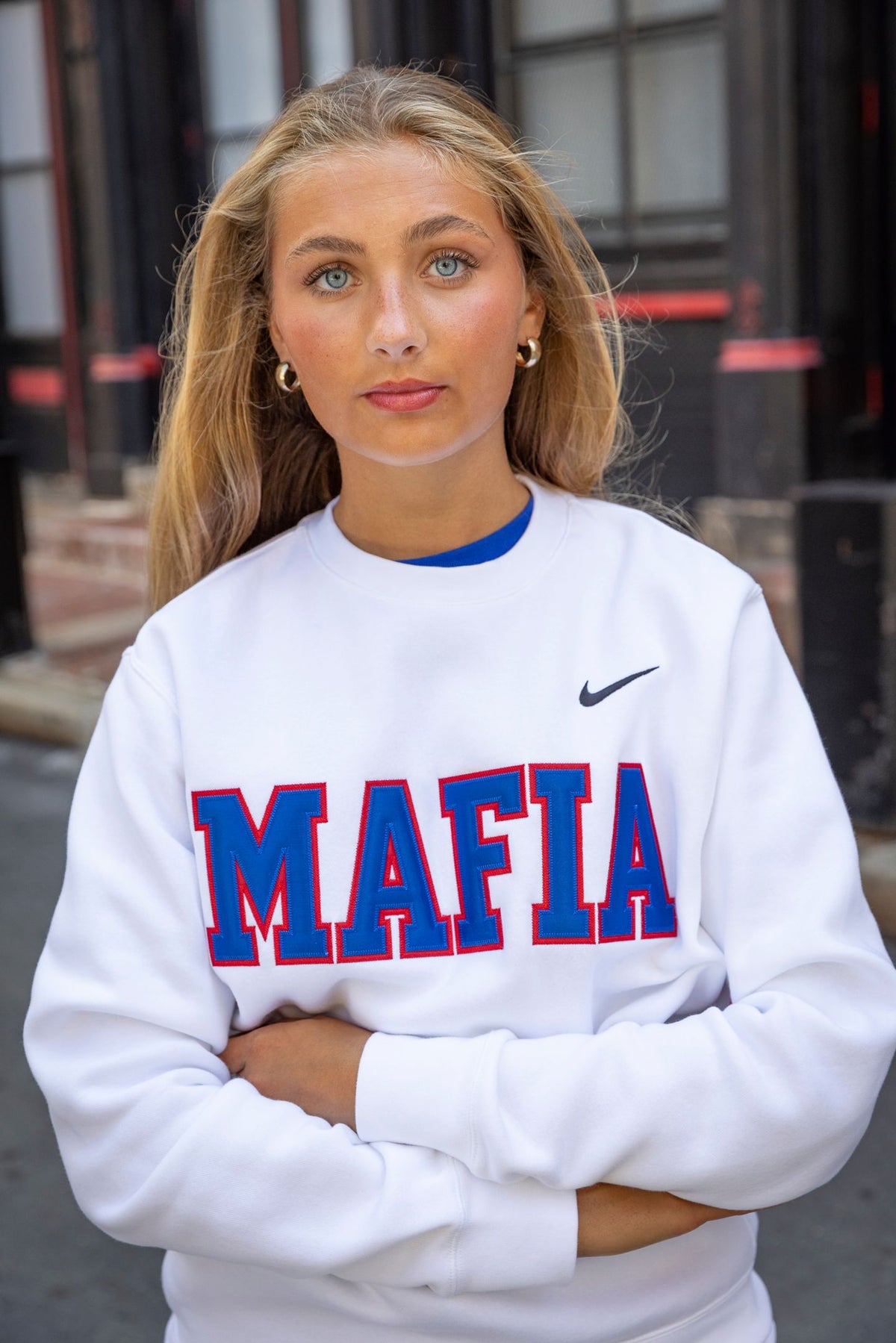 Outdoor model shot wearing white MAFIA crewneck with sewn-on lettering