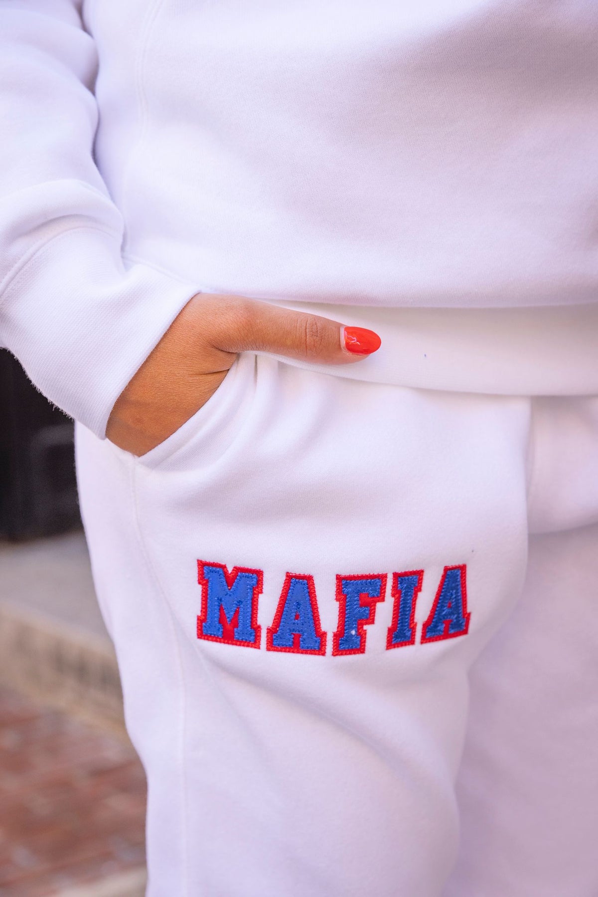 Close-up of white MAFIA joggers sewn-on tackle twill lettering