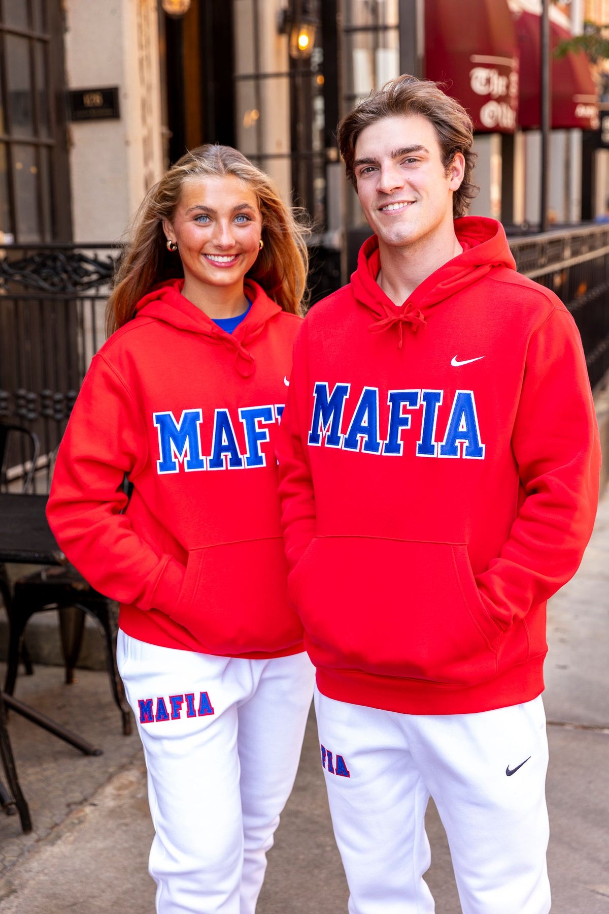Male and female models wearing red MAFIA hoodies