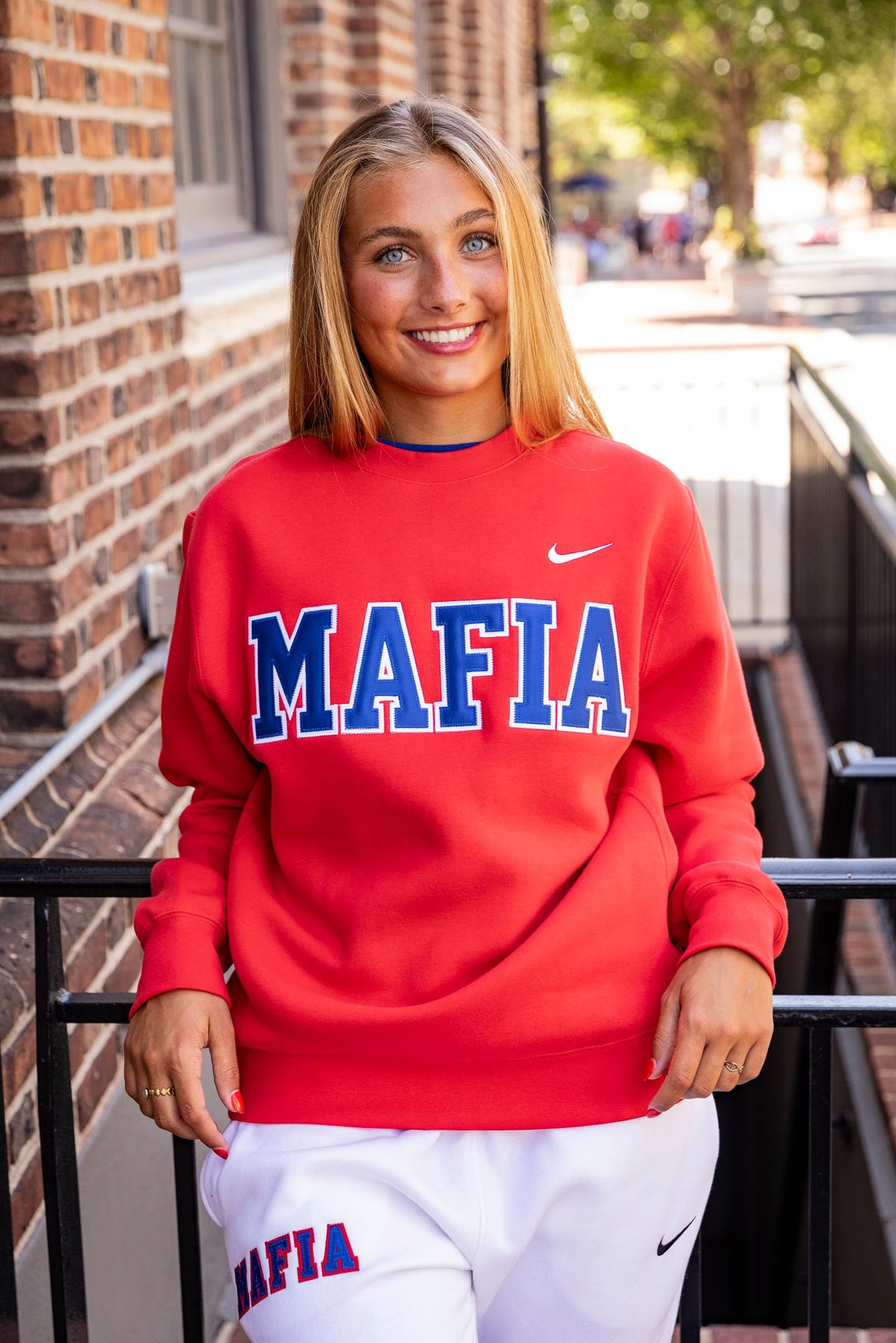 Female model wearing red MAFIA crewneck with sewn-on lettering