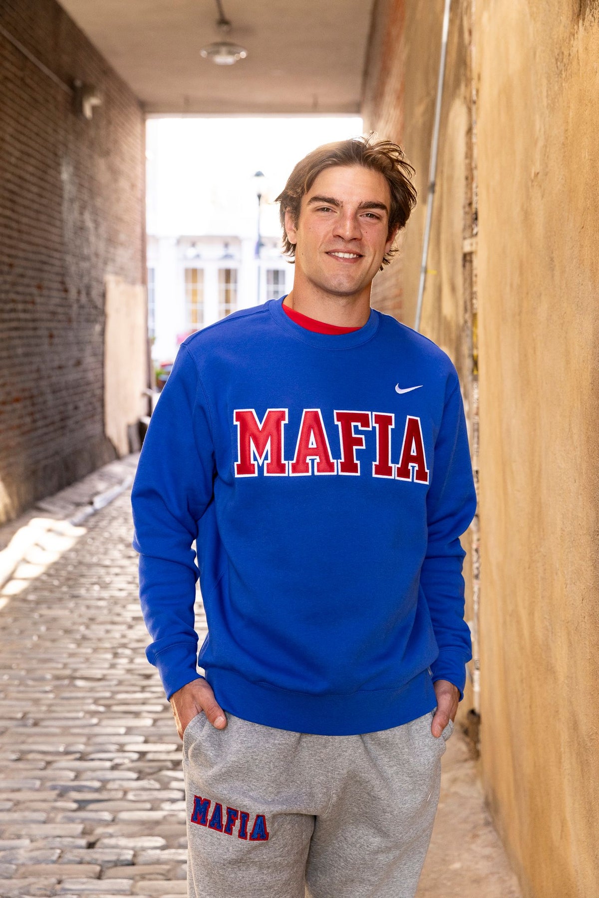 Male model wearing royal blue MAFIA crewneck with sewn-on lettering