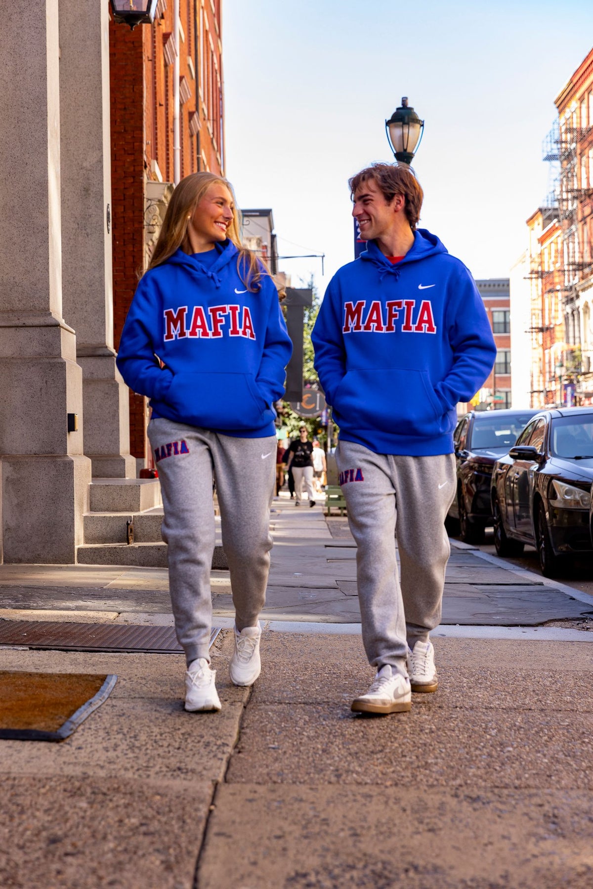 Male and female models wearing royal blue MAFIA hoodies