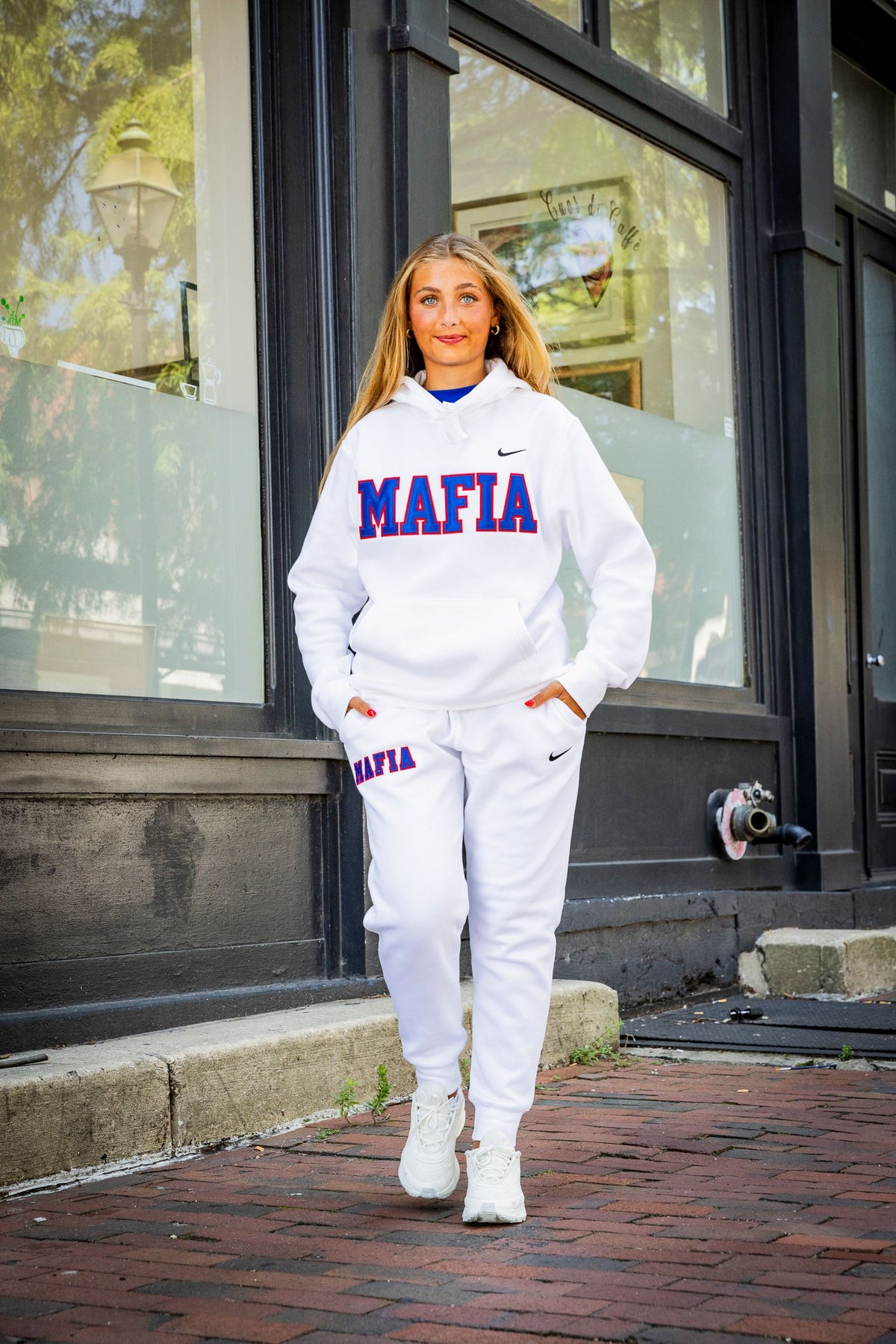 Female model wearing white MAFIA hoodie with sewn-on lettering