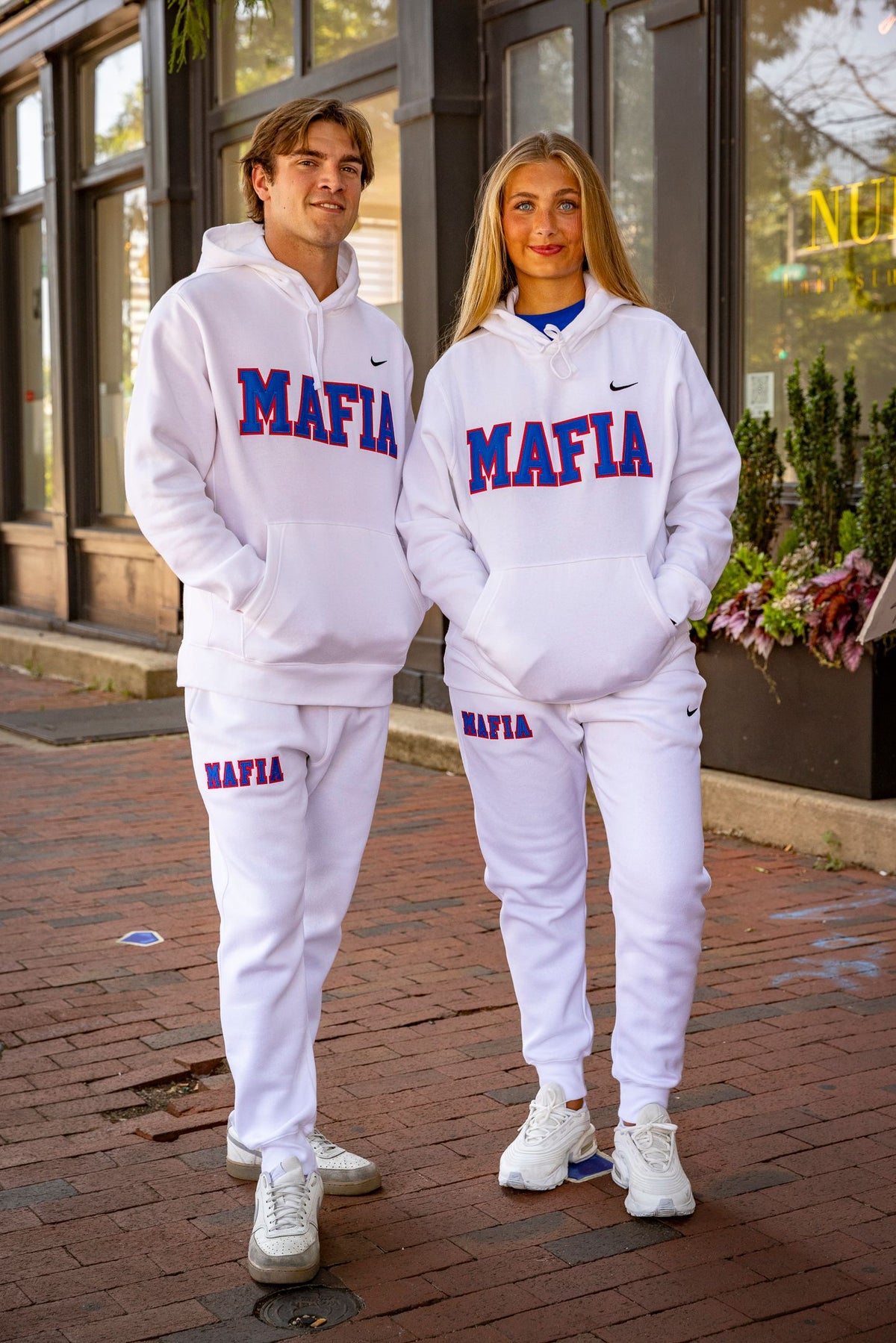 Male and female models wearing white MAFIA hoodies