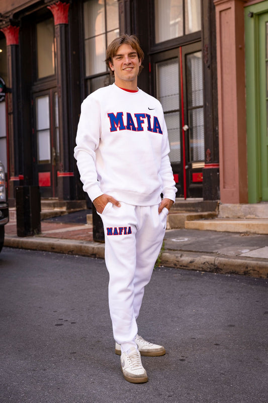 Model wearing white MAFIA joggers with sewn-on lettering